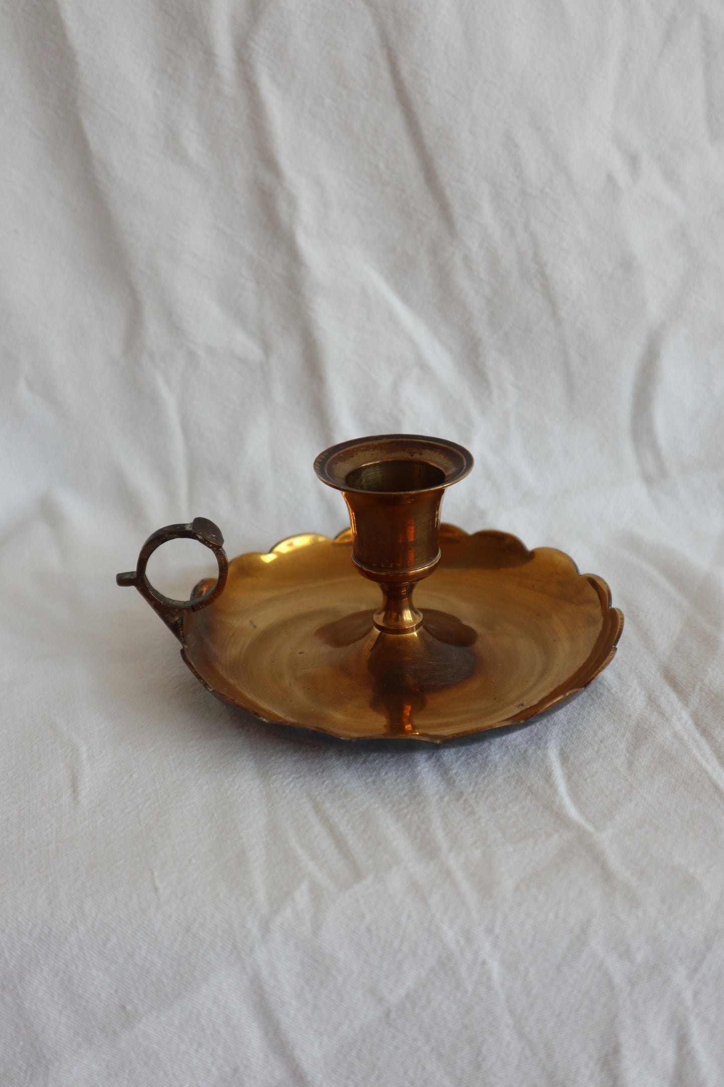Pair of scalloped brass candlestick holders