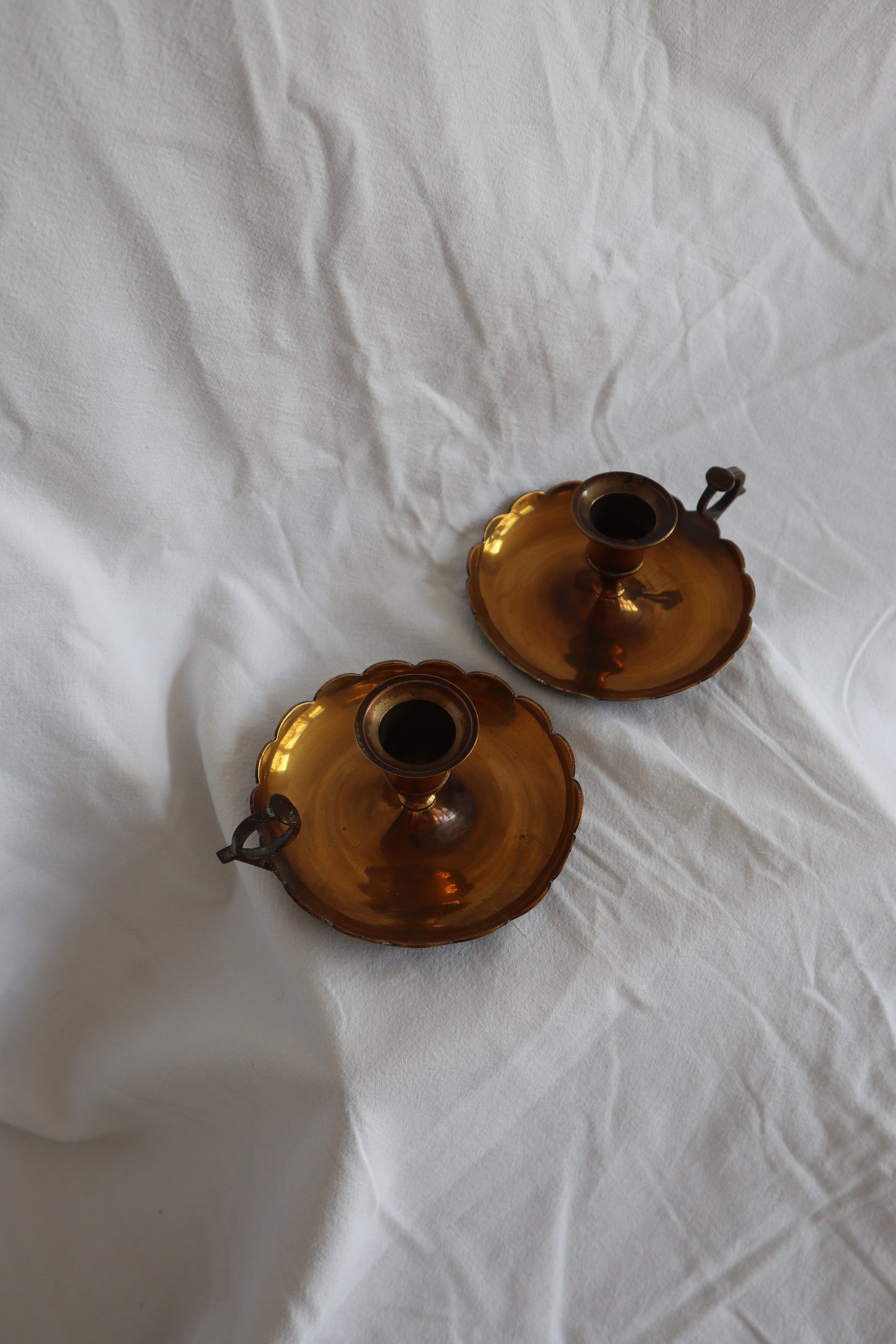 Pair of scalloped brass candlestick holders