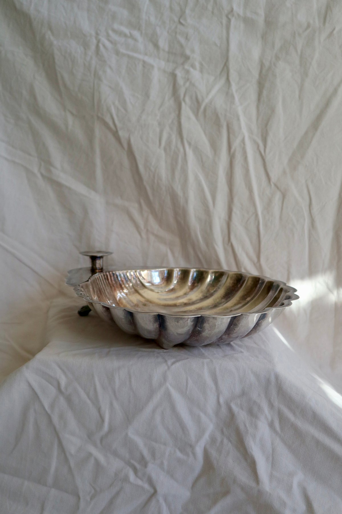 Large silver shell serving platter with candleholder