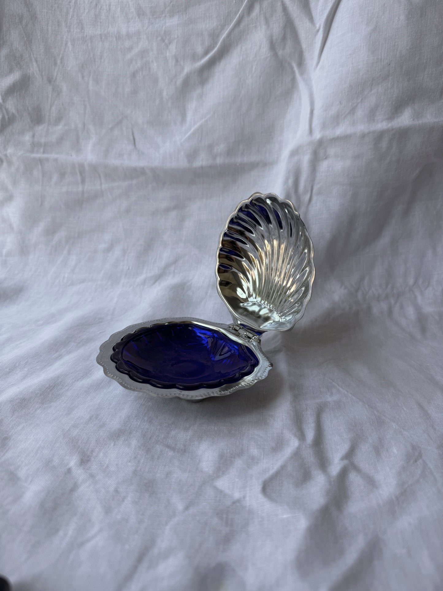 Silver plated shell caviar dish with cobalt blue glass insert