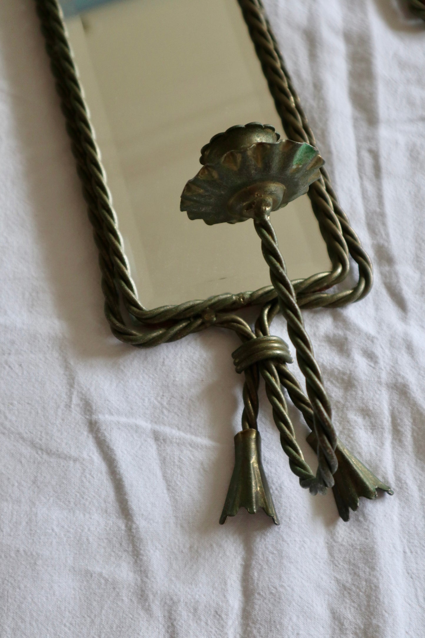 Pair of ornate braided metal and tassel mirror sconces
