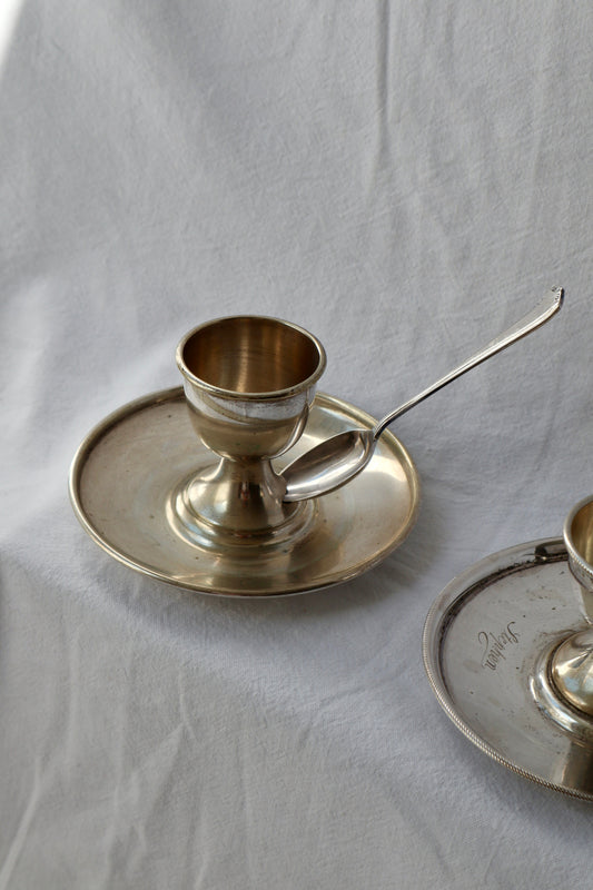 Pair of antique silver-plated egg cups with spoons