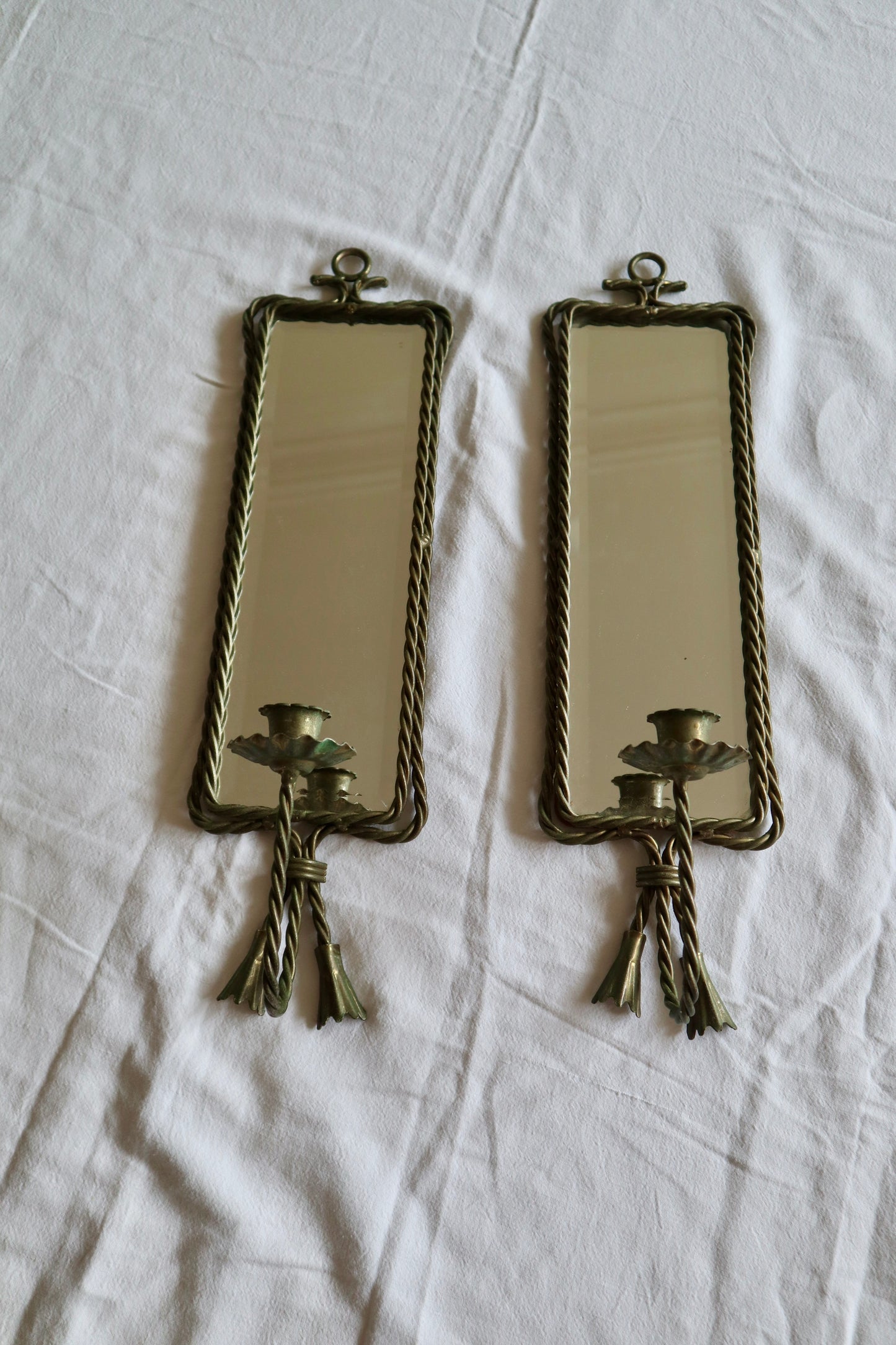 Pair of ornate braided metal and tassel mirror sconces