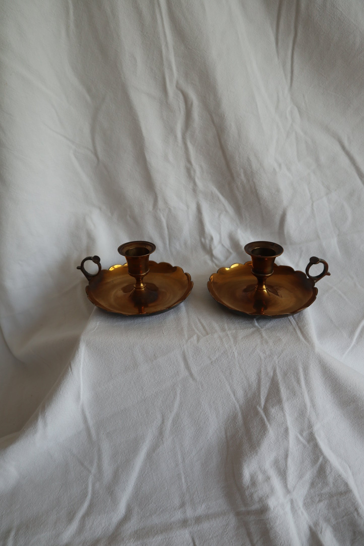 Pair of scalloped brass candlestick holders