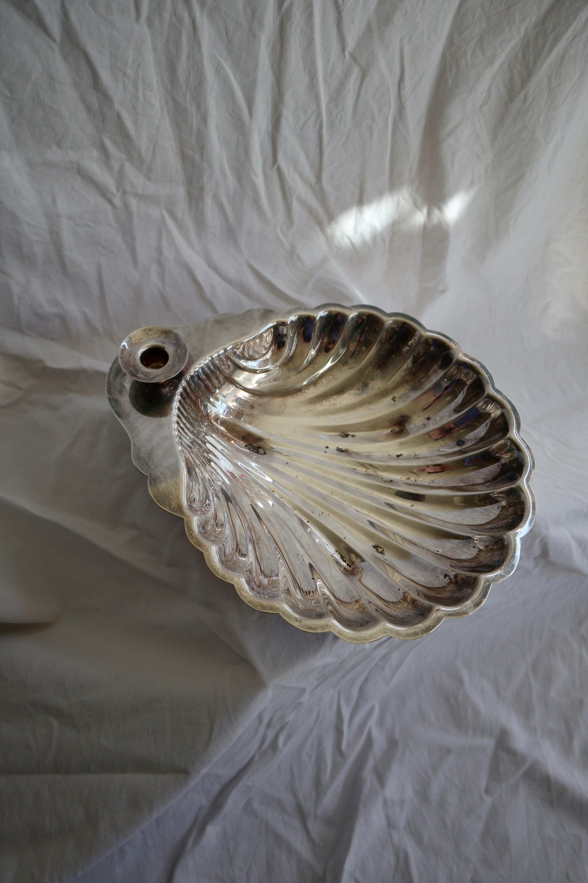 Large silver shell serving platter with candleholder