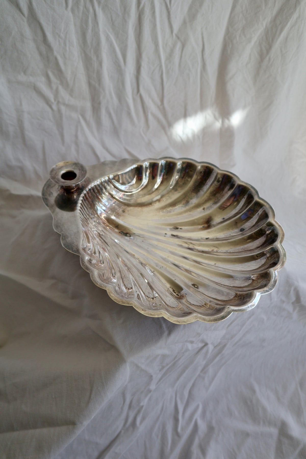 Large silver shell serving platter with candleholder