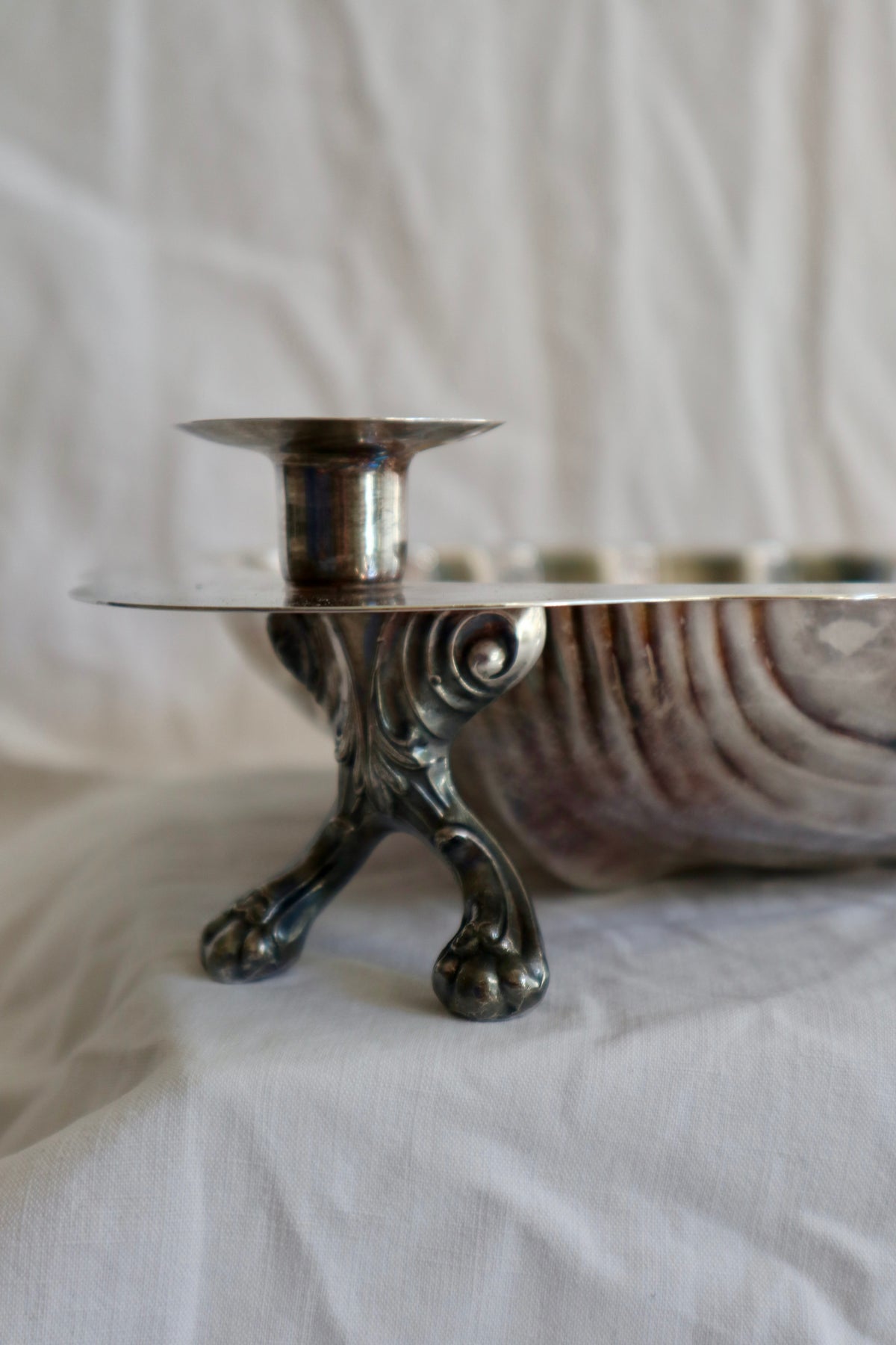 Large silver shell serving platter with candleholder