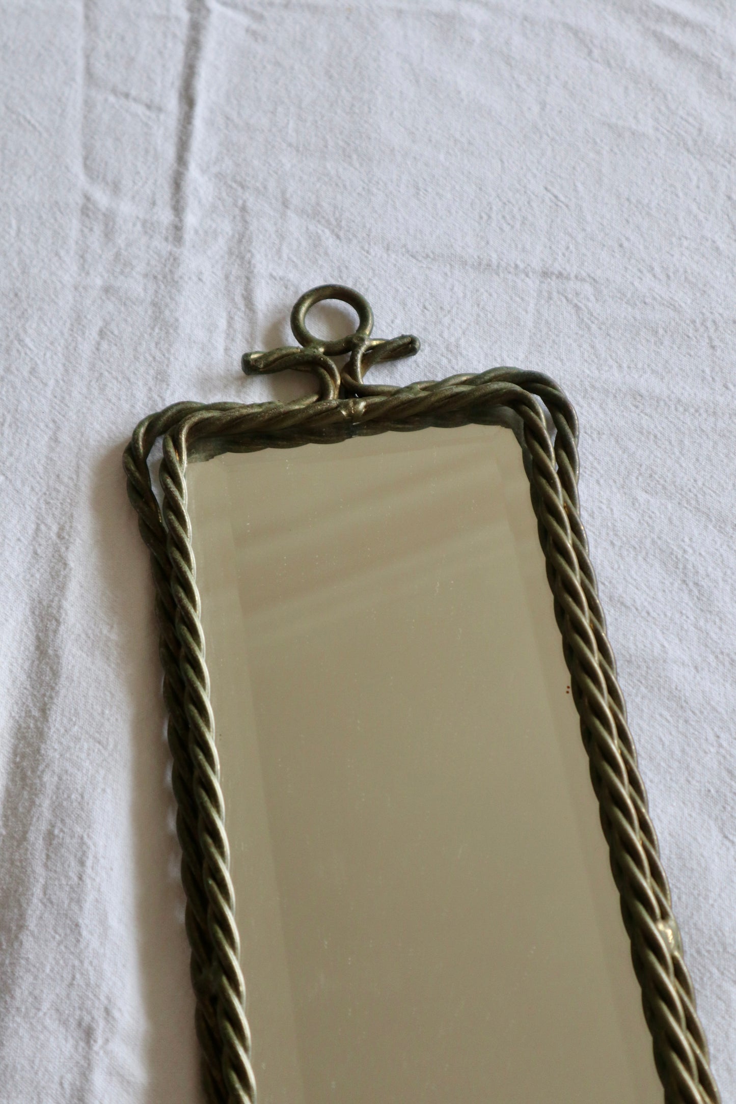 Pair of ornate braided metal and tassel mirror sconces