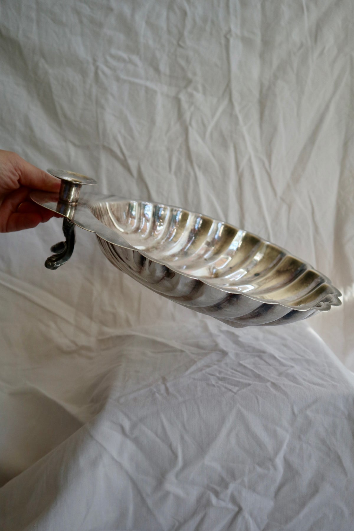 Large silver shell serving platter with candleholder