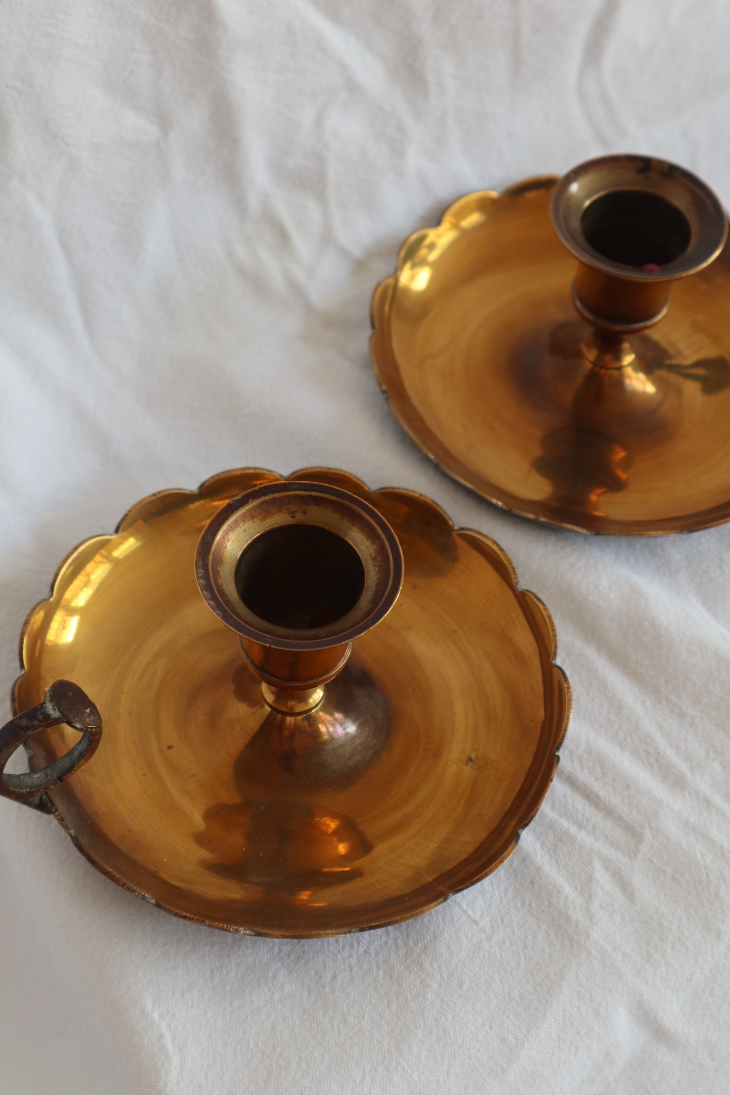 Pair of scalloped brass candlestick holders