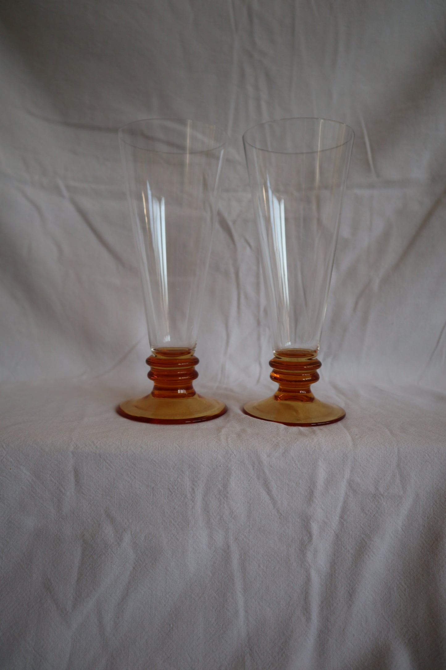 Set of 5 amber glass bobbin-stem mid century flutes